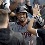 Arizona Diamondbacks' Eduardo Escobar (14) is congratulated in the dugout after hitting a solo home run during the second inning of a baseball game against the Los Angeles Dodgers, Saturday, Sept. 1, 2018, in Los Angeles. (AP Photo/Michael Owen Baker)
