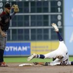 Houston Astros' Josh Reddick (22) tumbles after being tagged out by Arizona Diamondbacks second baseman Ketel Marte while trying to stretch a single into a double during the second inning of baseball game Sunday, Sept. 16, 2018, in Houston. (AP Photo/David J. Phillip)
