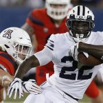 BYU running back Squally Canada (22) gets away from Arizona linebacker Colin Schooler during the first half of an NCAA college football game, Saturday, Sept. 1, 2018, in Tucson, Ariz. (AP Photo/Rick Scuteri)