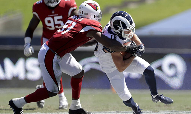 Los Angeles Rams wide receiver Cooper Kupp, right, is tackled by Arizona Cardinals linebacker Geral...