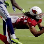 Arizona Cardinals wide receiver Larry Fitzgerald (11) makes a catch as Seattle Seahawks cornerback Shaquill Griffin defends during the first half of an NFL football game, Sunday, Sept. 30, 2018, in Glendale, Ariz. (AP Photo/Ross D. Franklin)