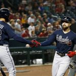Atlanta Braves' Ender Inciarte, right, celebrates with Nick Markakis after scoring against the Arizona Diamondbacks during the first inning of a baseball game Thursday, Sept. 6, 2018, in Phoenix. (AP Photo/Ross D. Franklin)