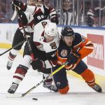 Arizona Coyotes ' Christian Fischer (36) and Edmonton Oilers' Connor McDavid (97) vie for the puck during the second period of an NHL hockey preseason game Thursday, Sept. 27, 2018, in Edmonton, Alberta. (Jason Franson/The Canadian Press via AP)