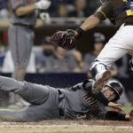 Arizona Diamondbacks' John Ryan Murphy, below, is tagged out at home by San Diego Padres catcher Francisco Mejia on a ball hit by Eduardo Escobar during the seventh inning of a baseball game Friday, Sept. 28, 2018, in San Diego. (AP Photo/Gregory Bull)