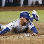 Los Angeles Dodgers' Tim Locastro (70) slides across home plate to score a run against the Arizona Diamondbacks during the seventh inning of a baseball game, Monday, Sept. 24, 2018, in Phoenix. (AP Photo/Ross D. Franklin)