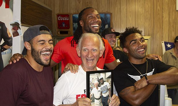 D.J. Foster (left), Larry Fitzgerald (center) and Christian Kirk (right) surround and share a laugh...