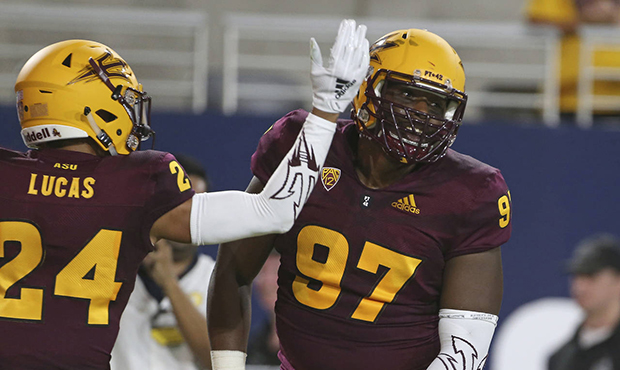 Arizona State defensive lineman Shannon Forman (97) celebrates with teammate Chase Lucas after retu...