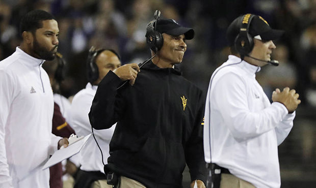 Arizona State head coach Herm Edwards, second from right, reacts to a play on the sideline during t...