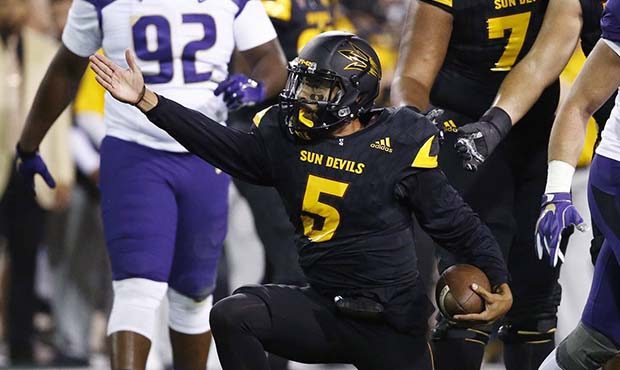 Arizona State quarterback Manny Wilkins (5) signals a first down against Washington during the firs...