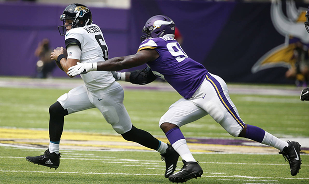 Jacksonville Jaguars quarterback Cody Kessler, left, is sacked by Minnesota Vikings defensive end I...