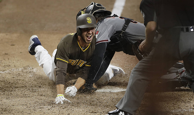 San Diego Padres' Javy Guerra scores the winning run off a double by Freddy Galvis during the fifte...