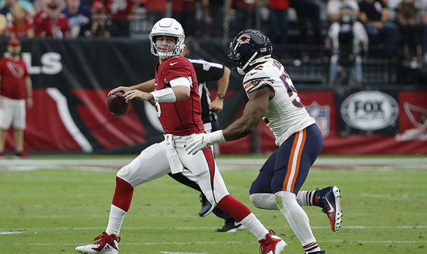 Arizona Cardinals quarterback Josh Rosen, left, looks to throw the ball as he is pressured by Chica...