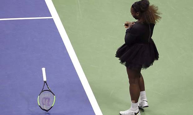 Serena Williams slams her racket on court during the women's final of the U.S. Open tennis tourname...