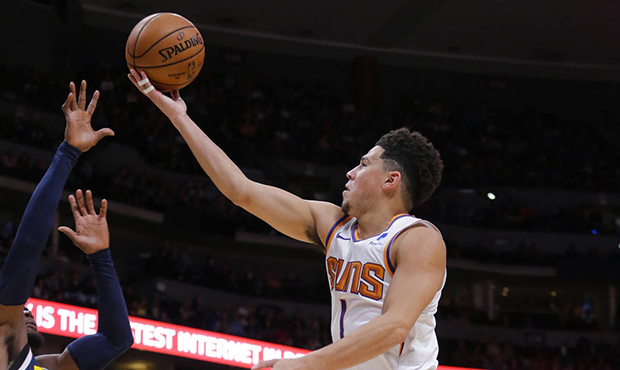 Phoenix Suns guard Devin Booker (1) goes up to shoot against Denver Nuggets forward Paul Millsap (4...