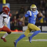 UCLA quarterback Dorian Thompson-Robinson, right, runs the ball as Arizona safety Jarrius Wallace gives chase during the first half of an NCAA college football game, Saturday, Oct. 20, 2018, in Pasadena, Calif. (AP Photo/Mark J. Terrill)