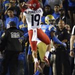 Arizona wide receiver Shawn Poindexter, left, makes a touchdown catch as UCLA defensive back Colin Samuel defends during the first half of an NCAA college football game, Saturday, Oct. 20, 2018, in Pasadena, Calif. (AP Photo/Mark J. Terrill)