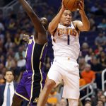 Phoenix Suns guard Devin Booker (1) rebounds over Los Angeles Lakers guard Lance Stephenson during the first half of an NBA basketball game, Wednesday, Oct. 24, 2018, in Phoenix. (AP Photo/Matt York)