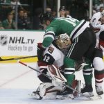 Arizona Coyotes goaltender Antti Raanta (32) makes a save as Dallas Stars left wing Jamie Benn (14) collides with him and Coyotes defenseman Oliver Ekman-Larsson (23) during the first period of an NHL hockey game in Dallas, Thursday, Oct. 4, 2018. (AP Photo/Michael Ainsworth)