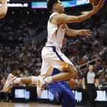Phoenix Suns guard Devin Booker shoots against the Dallas Mavericks during the second half of an NBA basketball game, Wednesday, Oct. 17, 2018, in Phoenix. The Suns won 121-100. (AP Photo/Matt York)