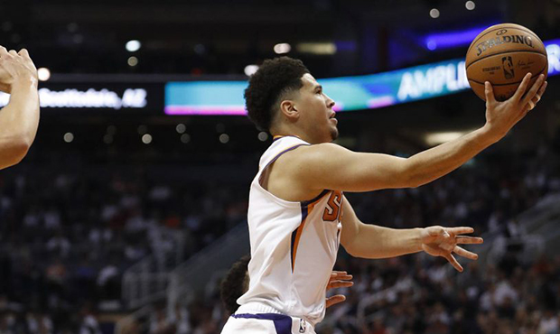 Phoenix Suns guard Devin Booker shoots against the Dallas Mavericks during the second half of an NB...
