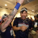 Los Angeles Dodgers starting pitcher Hyun-Jin Ryu, of South Korea, is sprayed with champaign by teammates in the clubhouse after the team's 5-2 win against the Colorado Rockies in a tiebreaker baseball game, Monday, Oct. 1, 2018, in Los Angeles. (AP Photo/Jae C. Hong)