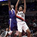 Portland Trail Blazers guard Anfernee Simons, right, drives to the basket on Phoenix Suns guard Davon Reed during the second half of an NBA preseason basketball game in Portland, Ore., Wednesday, Oct. 10, 2018. (AP Photo/Steve Dykes)