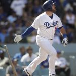 Los Angeles Dodgers' Max Muncy watches the flight of his two-run home run during the fifth inning of a tiebreaker baseball game against the Colorado Rockies, Monday, Oct. 1, 2018, in Los Angeles. (AP Photo/Jae C. Hong)