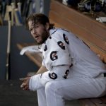 Los Angeles Dodgers starting pitcher Clayton Kershaw sits in the dugout during the first inning in Game 5 of the World Series baseball game against the Boston Red Sox on Sunday, Oct. 28, 2018, in Los Angeles. (AP Photo/Jae C. Hong)