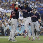 Boston Red Sox's Steve Pearce celebrates with J.D. Martinez (28) and Andrew Benintendi after hitting a two-run home run during the first inning in Game 5 of the World Series baseball game on Sunday, Oct. 28, 2018, in Los Angeles. (AP Photo/David J. Phillip)