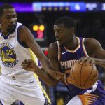 Phoenix Suns' Josh Jackson, right, drives the ball against Golden State Warriors' Kevin Durant (35) during the first half of a preseason NBA basketball game Monday, Oct. 8, 2018, in Oakland, Calif. (AP Photo/Ben Margot)