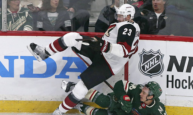 Arizona Coyotes' Oliver Ekman-Larsson, left, of Sweden, is upended in a collision with Minnesota Wi...