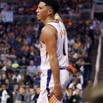 Phoenix Suns guard Devin Booker (1) grabs his leg after a play as he takes himself out of the game during the second half of an NBA basketball game against the Los Angeles Lakers, Wednesday, Oct. 24, 2018, in Phoenix. (AP Photo/Matt York)