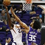 Phoenix Suns center Deandre Ayton (22) tries to get off a shot over Sacramento Kings forward Marvin Bagley III (35) during the first half of a preseason NBA basketball game Monday, Oct. 1, 2018, in Phoenix. (AP Photo/Ross D. Franklin)