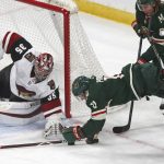 Minnesota Wild's Zach Parise, right, dives for the puck as Arizona Coyotes' goalie Darcy Kuemper reaches for it in the second period of an NHL hockey game Tuesday, Oct. 16, 2018, in St. Paul, Minn. (AP Photo/Jim Mone)