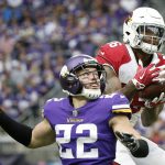 Arizona Cardinals tight end Ricky Seals-Jones , right, catches a pass over Minnesota Vikings free safety Harrison Smith (22) during the first half of an NFL football game, Sunday, Oct. 14, 2018, in Minneapolis. (AP Photo/Bruce Kluckhohn)