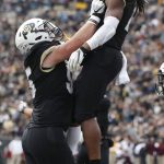 Colorado offensive lineman Brett Tonz, left, hoists wide receiver Laviska Shenault Jr. into the air to celebrate his run for a touchdown against Arizona State in the first half of an NCAA college football game Saturday, Oct. 6, 2018, in Boulder, Colo. (AP Photo/David Zalubowski)
