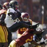 Arizona State running back Eno Benjamin (3) leaps over Southern California cornerback Ajene Harris during the first half of an NCAA college football game Saturday, Oct. 27, 2018, in Los Angeles. (AP Photo/Marcio Jose Sanchez)