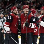 Arizona Coyotes left wing Lawson Crouse (67) celebrates with Kevin Connauton (44) and Niklas Hjalmarsson (4) after scoring a goal in the third period of an NHL hockey game against the Vancouver Canucks, Thursday, Oct. 25, 2018, in Glendale, Ariz. Arizona defeated Vancouver 4-1. (AP Photo/Rick Scuteri)