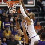 Phoenix Suns center Tyson Chandler dunks over Los Angeles Lakers center JaVale McGee (7) during the first half of an NBA basketball game, Wednesday, Oct. 24, 2018, in Phoenix. (AP Photo/Matt York)