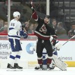 Arizona Coyotes' Brendan Perlini (11) celebrates the goal of teammate Jordan Oesterle in front of Tampa Bay Lightning's goalie Louis Domingue, right, and Braydon Coburn (55) during the first period of an NHL hockey game, Saturday, Oct. 27, 2018, in Glendale, Ariz. (AP Photo/Ralph Freso)