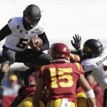 Arizona State quarterback Manny Wilkins, top left, leaps over Southern California linebacker Levi Jones, bottom left, during the first half of an NCAA college football game Saturday, Oct. 27, 2018, in Los Angeles. (AP Photo/Marcio Jose Sanchez)