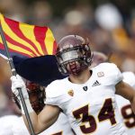 Arizona State linebacker Kyle Soelle carries out the state flag as the team takes the field to face Colorado in the first half of an NCAA college football game Saturday, Oct. 6, 2018, in Boulder, Colo. (AP Photo/David Zalubowski)