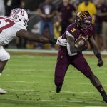 Arizona State's Eno Benjamin slips past Stanford's Michael Williams during the first half of an NCAA college football game Thursday, Oct. 18, 2018, in Tempe, Ariz. (AP Photo/Darryl Webb)