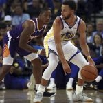Phoenix Suns' Isaiah Canaan, left, guards Golden State Warriors' Stephen Curry (30) during the first half of a preseason NBA basketball game Monday, Oct. 8, 2018, in Oakland, Calif. (AP Photo/Ben Margot)