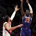 Phoenix Suns center Deandre Ayton shoots the ball over Portland Trail Blazers center Jusuf Nurkic during the first half of an NBA preseason basketball game in Portland, Ore., Wednesday, Oct. 10, 2018. (AP Photo/Steve Dykes)