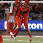 Arizona safety Scottie Young Jr., right, celebrates with Malik Hausman (23) after intercepting a pass in the first half during an NCAA college football game against Oregon, Saturday, Oct. 27, 2018, in Tucson, Ariz. (AP Photo/Rick Scuteri)