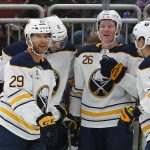 Buffalo Sabres defenseman Rasmus Dahlin (26) celebrates with Jason Pominville (29), Marco Scandella (6) and Evan Rodrigues (71) after scoring in the first period during an NHL hockey game against the Arizona Coyotes, Saturday, Oct. 13, 2018, in Glendale, Ariz. (AP Photo/Rick Scuteri)