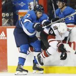 Winnipeg Jets' Ben Chiarot (7) checks Arizona Coyotes' Vinnie Hinostroza (13) during second-period NHL hockey game action in Winnipeg, Manitoba, Saturday, Oct. 20, 2018. (John Woods/The Canadian Press via AP)