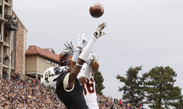 Colorado defensive back Delrick Abrams Jr., front, breaks up a pass intended for Arizona State tigh...