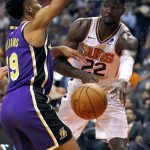 Phoenix Suns center Deandre Ayton (22) dishes around Los Angeles Lakers forward Johnathan Williams (19) during the second half of an NBA basketball game, Wednesday, Oct. 24, 2018, in Phoenix. (AP Photo/Matt York)